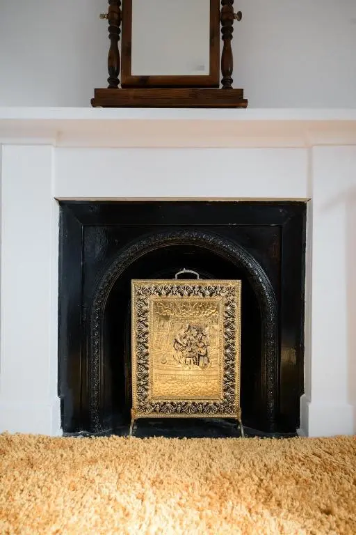 a fireplace with a picture in front of it at Crown Jewel - Inverness City Centre in Inverness