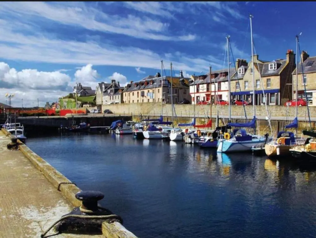 a group of boats are docked in a harbor at Spacious Modern Seaside Caravan in Lossiemouth