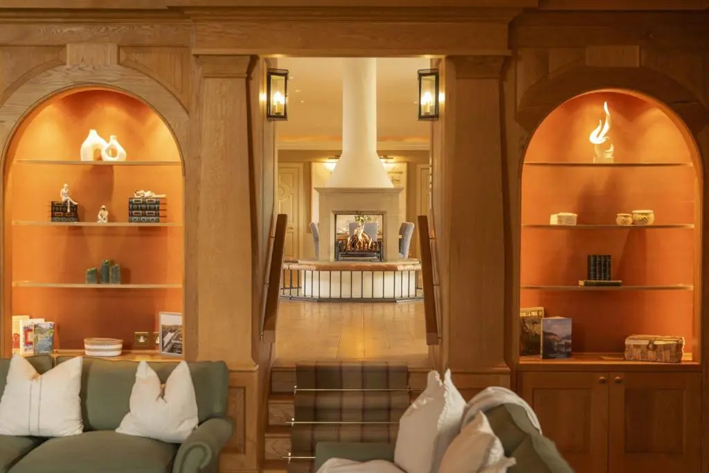 a living room with a couch and a fireplace at Drum Lodge in Nethy Bridge