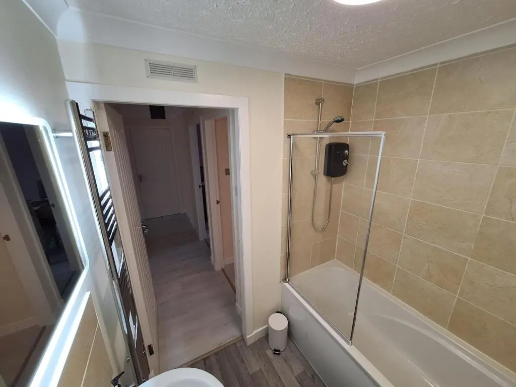a bathroom with a shower stall and a toilet at Modern Two Bed City Apartment!! in Inverness
