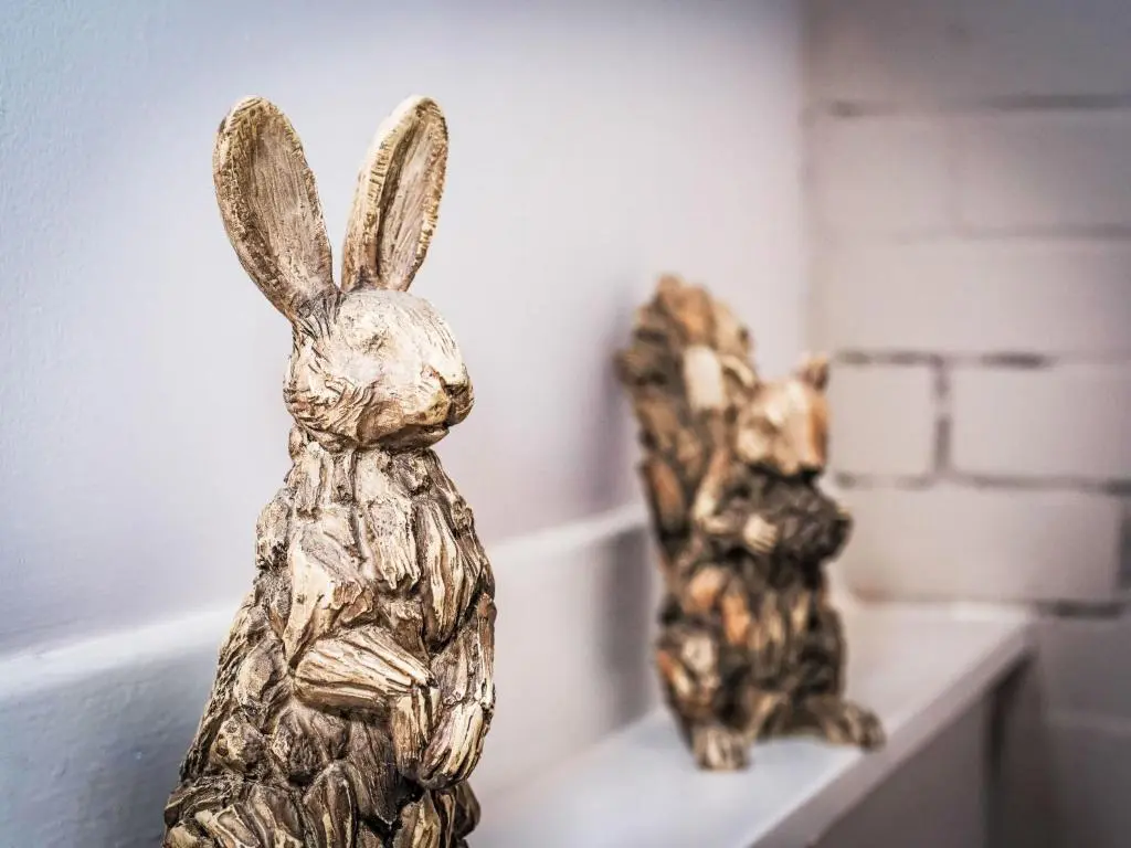 two statues of rabbits sitting on a shelf at Holiday Home Highland Garden Room by Interhome in Drumnadrochit