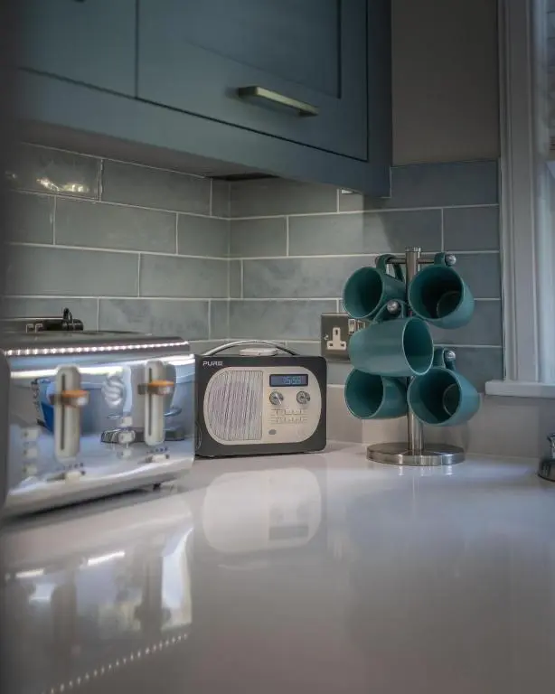 a kitchen counter with a stove and a toaster at Glen Tilt House in Bridge of Tilt