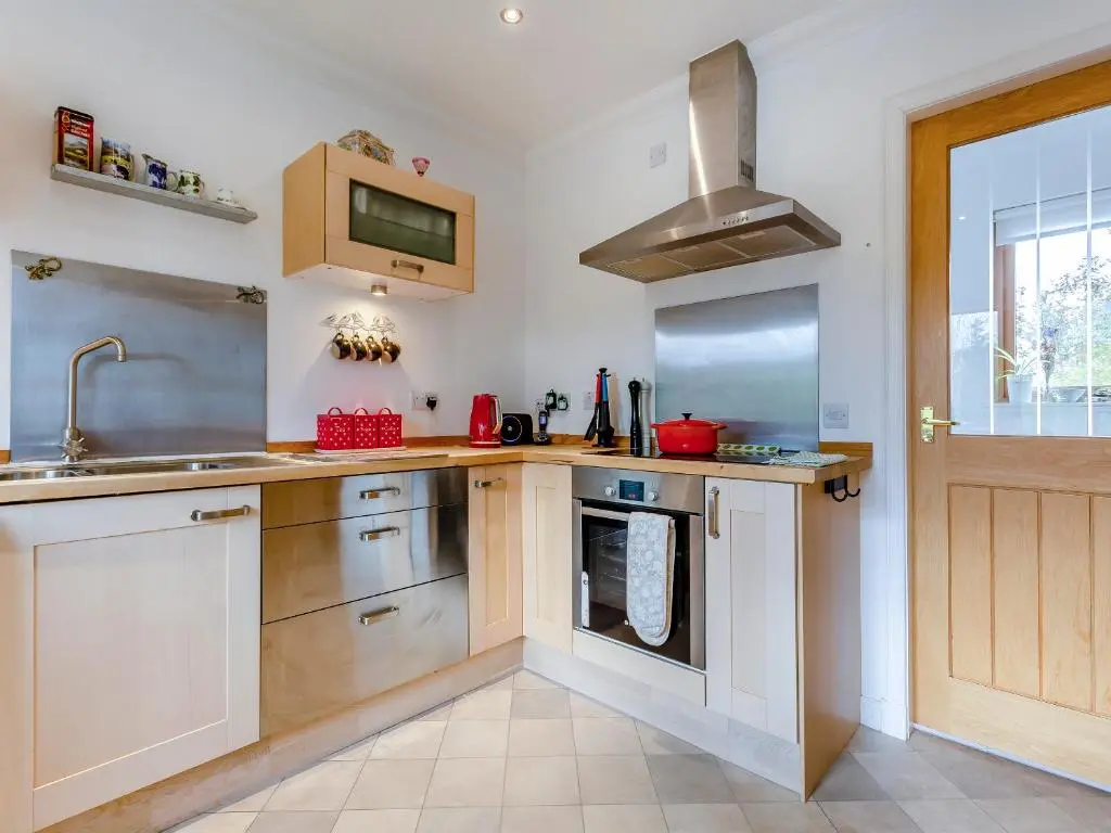 a kitchen with a sink and a stove at East Cottage in Cawdor
