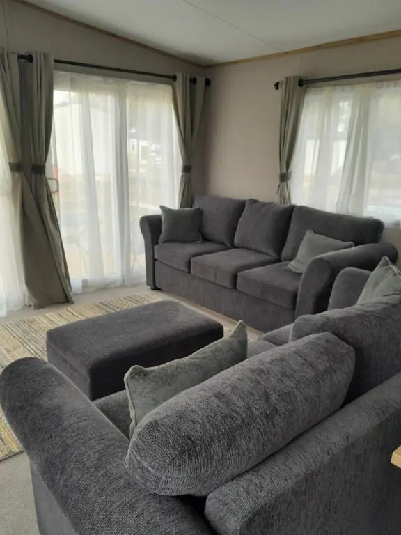 a living room with a couch and two couches at The Rowan in Boat of Garten