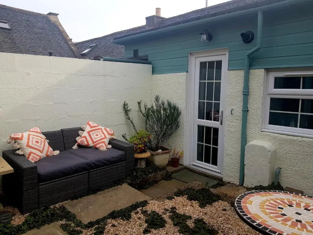 a couch sitting in the backyard of a house at Institution Road in Elgin