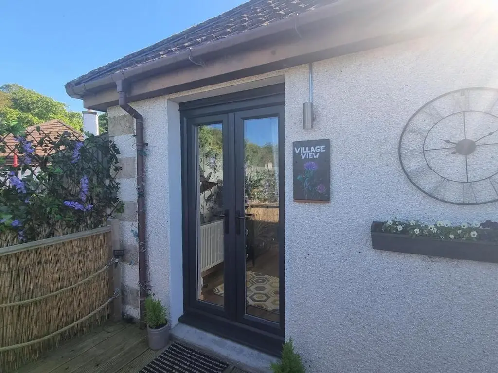 a front door of a house with a porch at Village view apartment in Auldearn