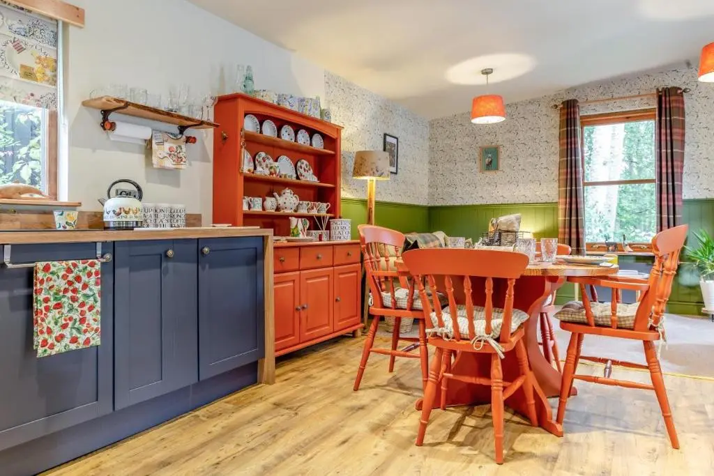 a kitchen with blue cabinets and a table and chairs at 2 Bed in Invergordon oc-c33073 in Invergordon
