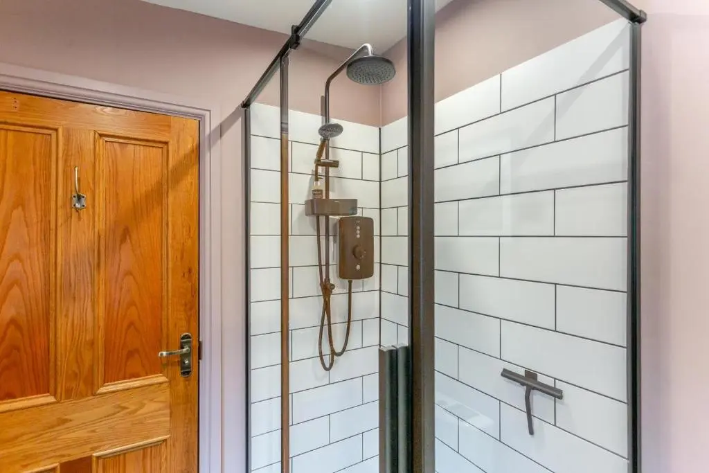 a shower with a glass door in a bathroom at 2 Bed in Invergordon oc-c33073 in Invergordon