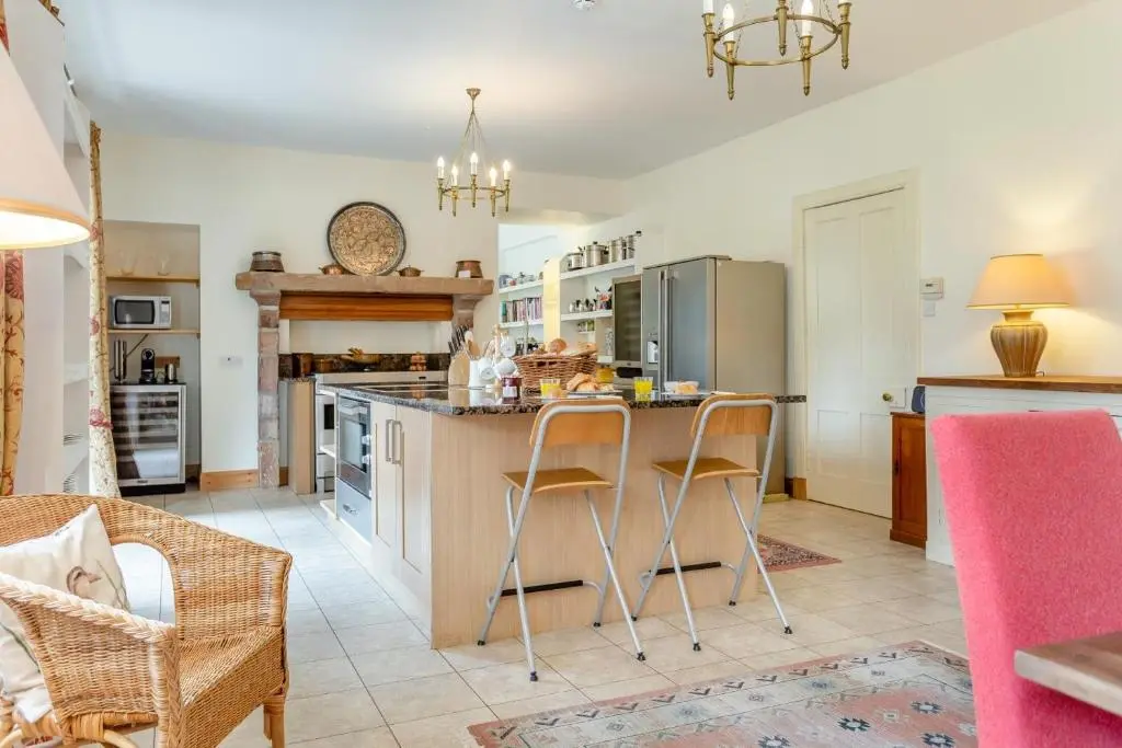 a kitchen with a island with bar stools at 8 Bed in Invergordon oc-p32711 in Invergordon