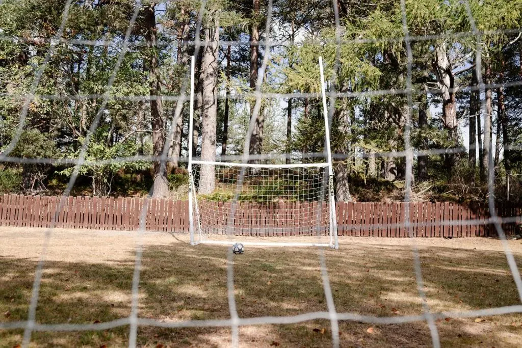 a soccer goal with a soccer ball in a field at Kintail - Seasgair Lodges in Inverdruie