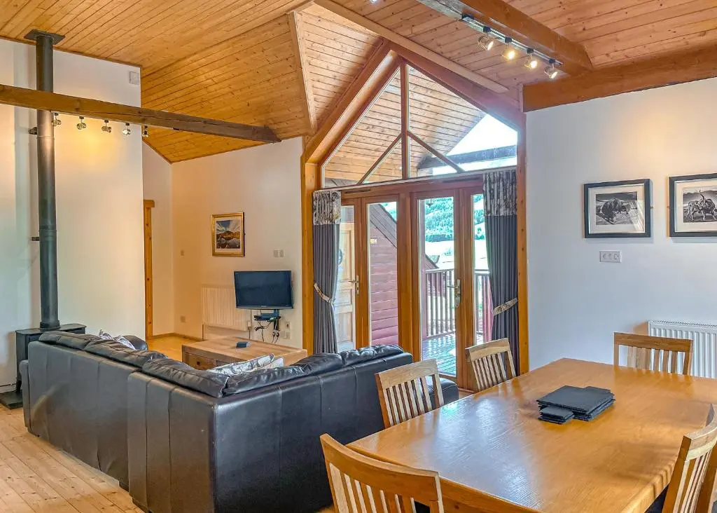 a living room with a table and a couch at Glen Clova Lodges in Angus