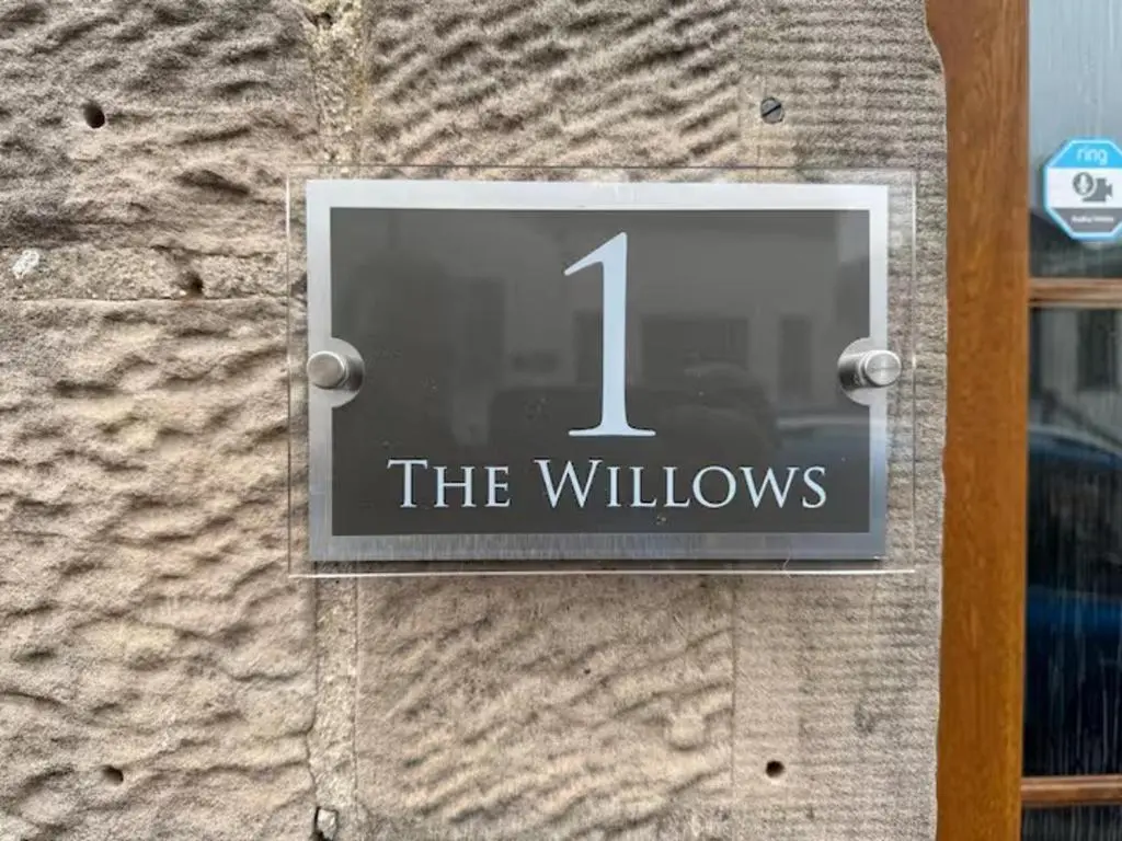a sign on a building that reads the willows at 1 Bed Flat - Sleeps 2 - Parking - Wifi in Nairn