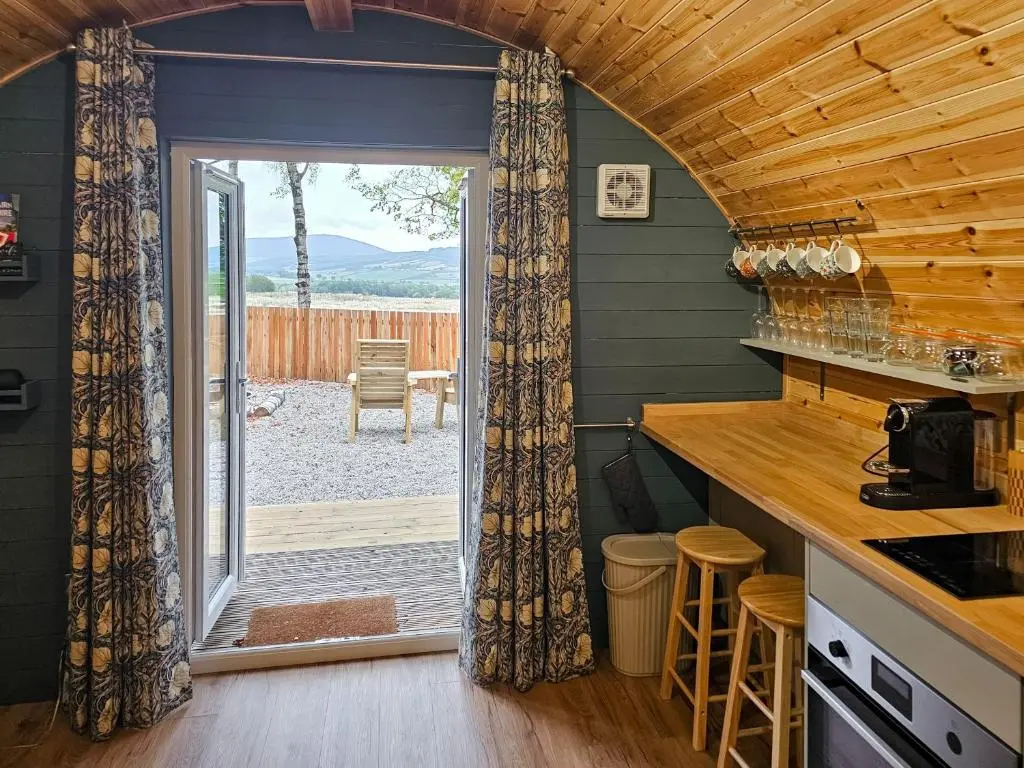 a kitchen with a door leading to a patio at Gallowhill Kirkside - Uk46515 in Newmill