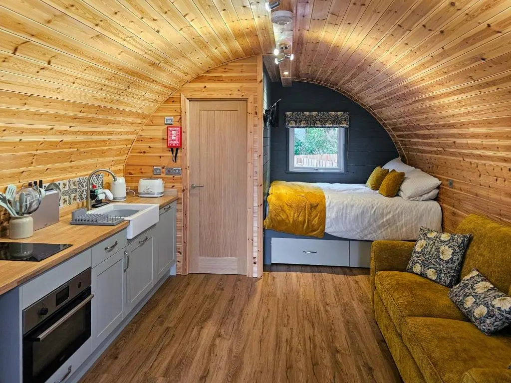 a kitchen and a bedroom in a tiny house at Gallowhill Kirkside - Uk46515 in Newmill