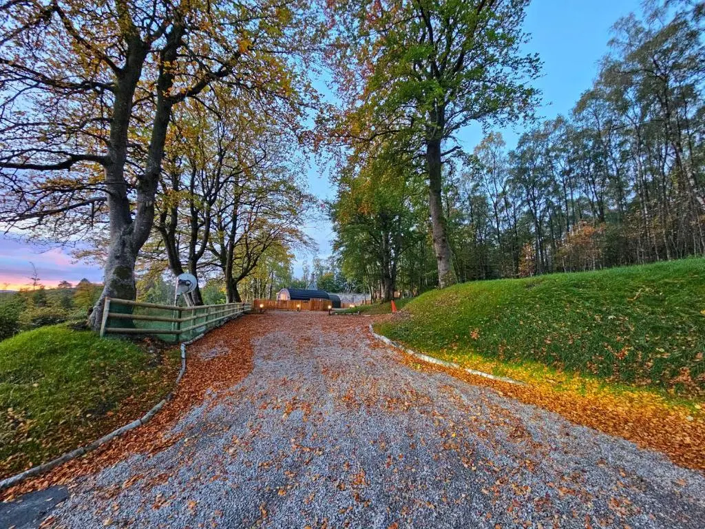 a gravel road with trees on the side of a hill at Gallowhill Kirkside - Uk46515 in Newmill