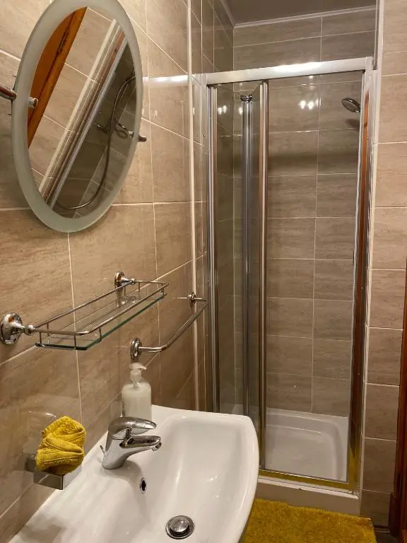 a bathroom with a sink and a shower at Georges holiday apt the blue suite in Inverness