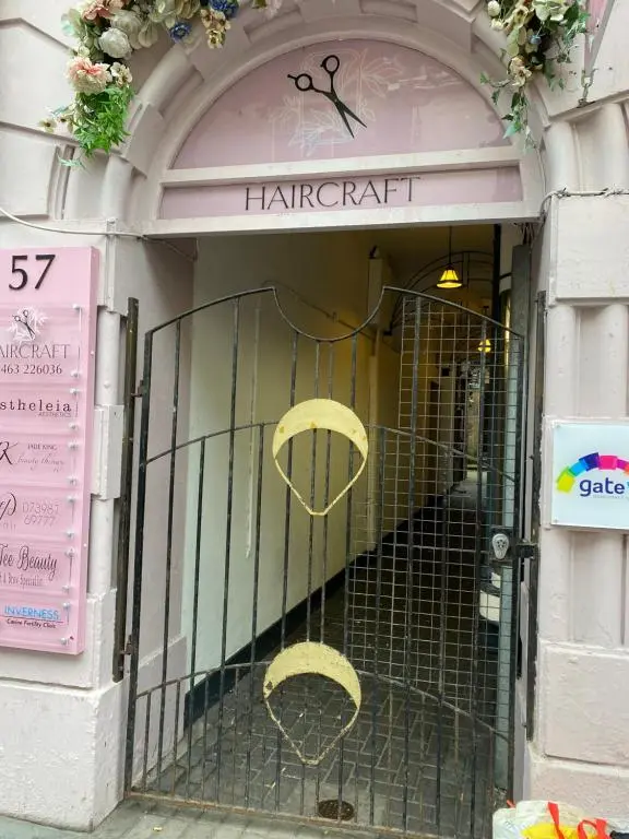 a front door of a harpett store with two chairs at Georges holiday apt the blue suite in Inverness