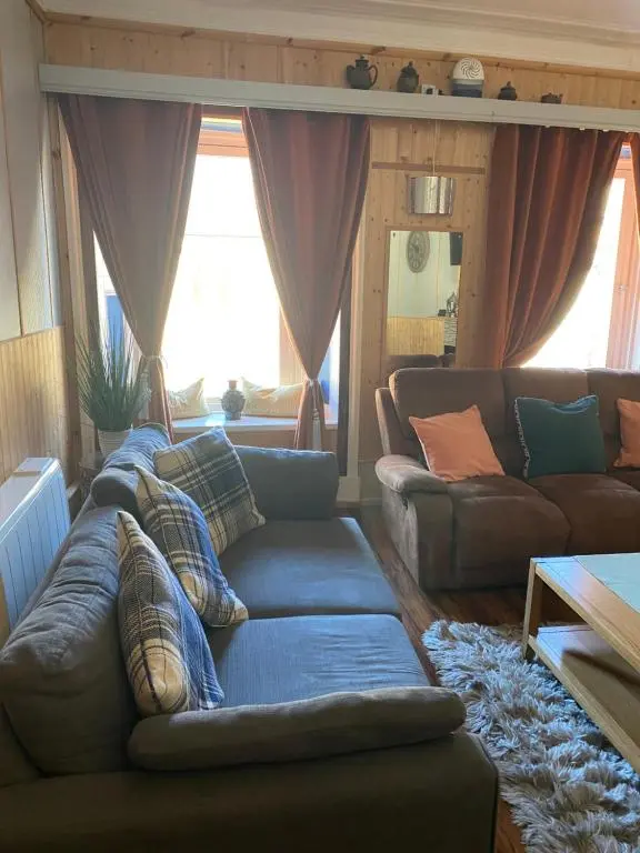 a living room with two couches and a couch at Georges holiday apt the blue suite in Inverness