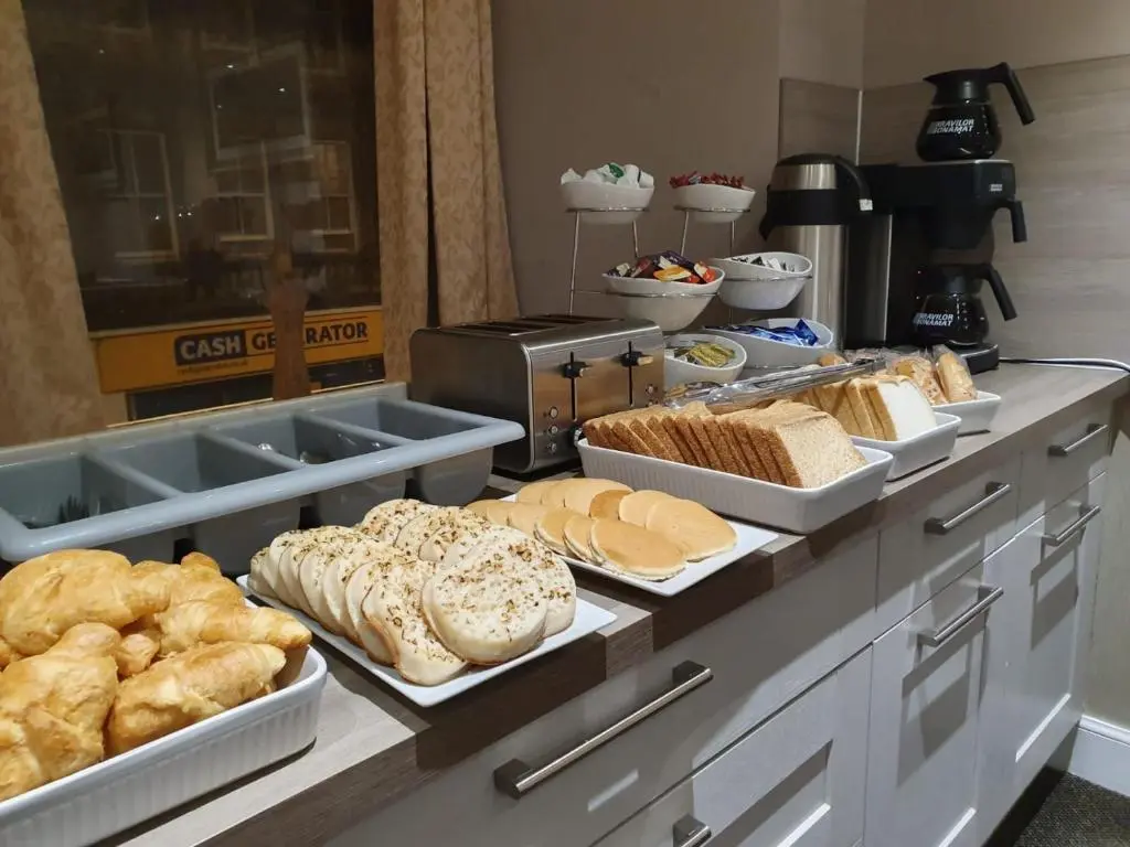 a buffet with different types of bread and pastries at The Waverley Guest House in Inverness