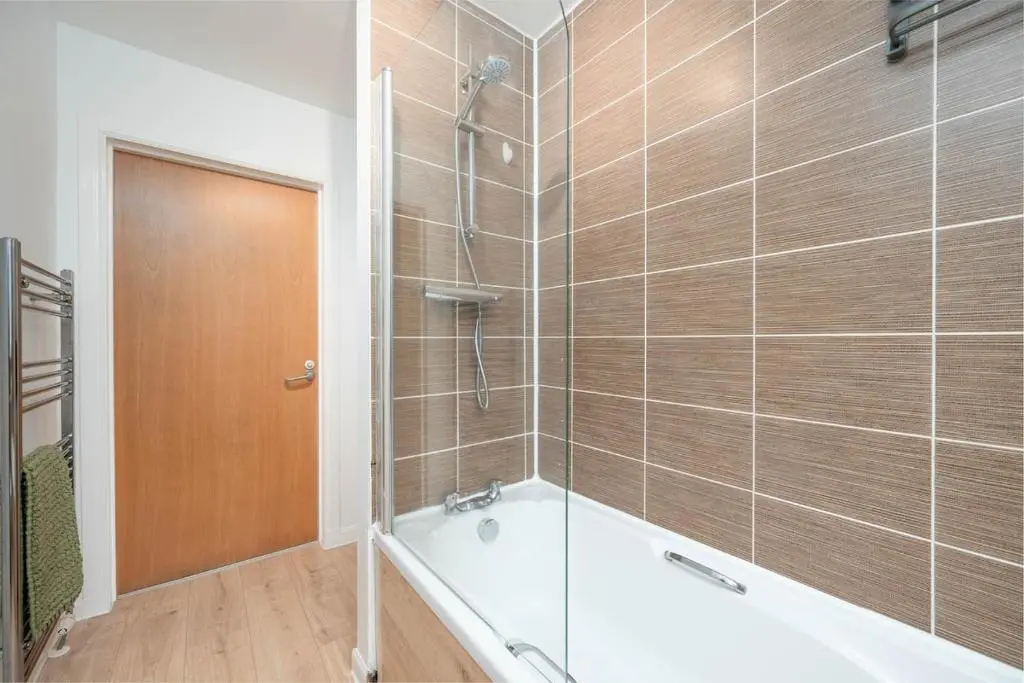 a bathroom with a bath tub and a shower at Aberdeen 2BR Flat Near Airport & City Centre in Aberdeen