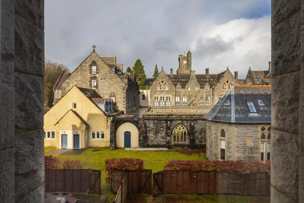 a large stone building with a yard in front of it at Abbey Church 20 in Fort Augustus