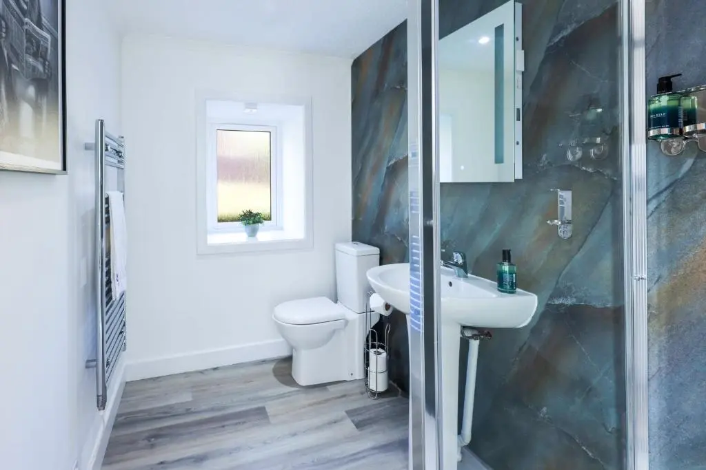 a bathroom with a toilet and a sink at Duffus Nights in Duffus