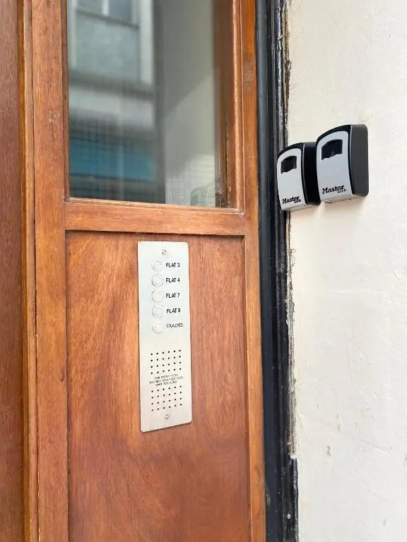 a wooden door with two security cameras on it at Lombard in Inverness