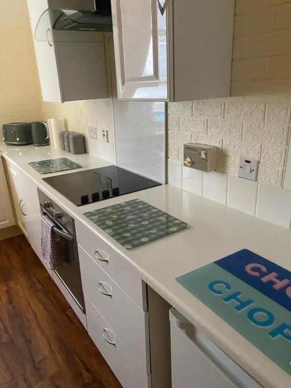 a kitchen with white counters and a stove top oven at Lombard in Inverness