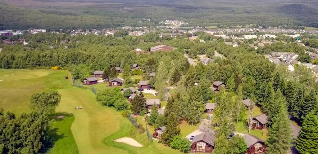 an overhead view of a golf course with houses and trees at Macdonald Spey Valley Resort in Aviemore