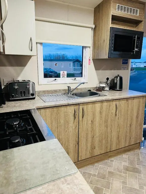 a kitchen with a sink and a window at Aurora Sky in Lossiemouth