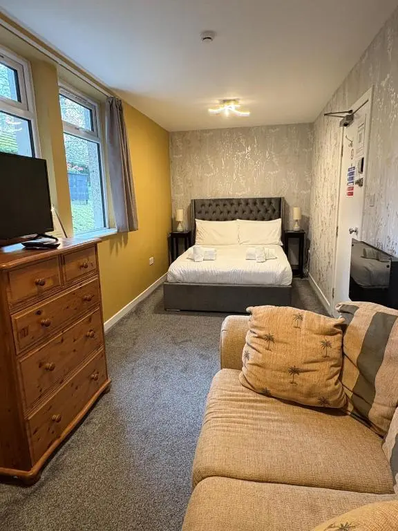 a living room with a bed and a couch at Cannich at RHA in Dalneigh