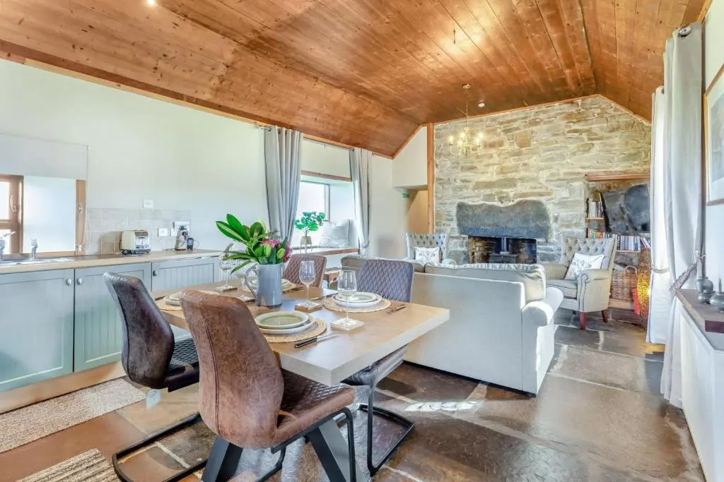 a kitchen and dining room with a table and chairs at 1 Bed in Wick oc-b33442 in Wick