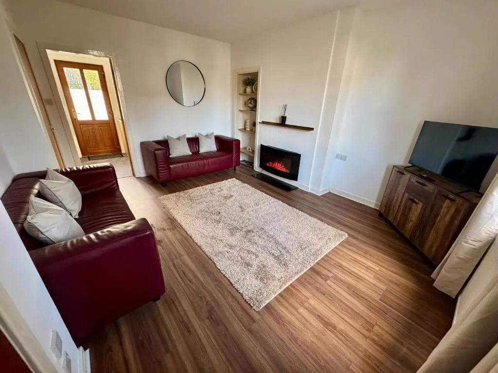 a living room with a couch and a fire place at Bruce Gardens Home in Inverness