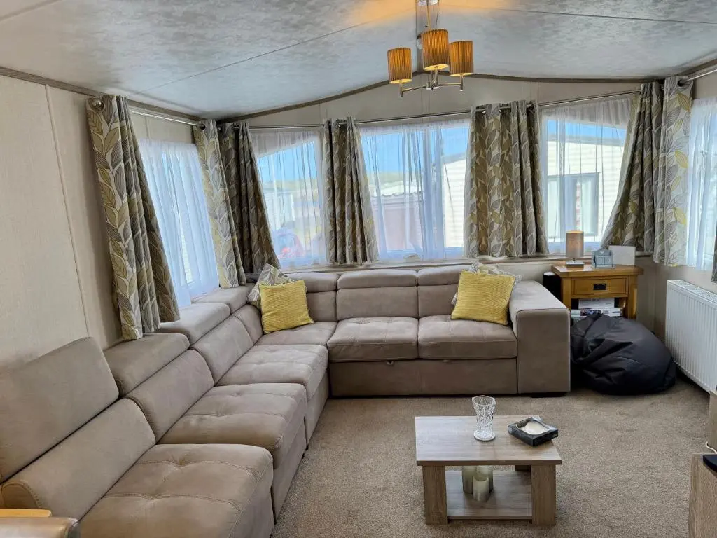 a living room with a couch and a table at Sutherland C14 in Lossiemouth