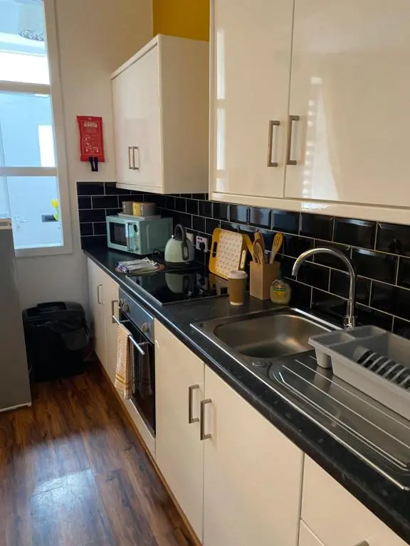 a kitchen with a sink and a microwave at Cozy one bedroom apt in Inverness