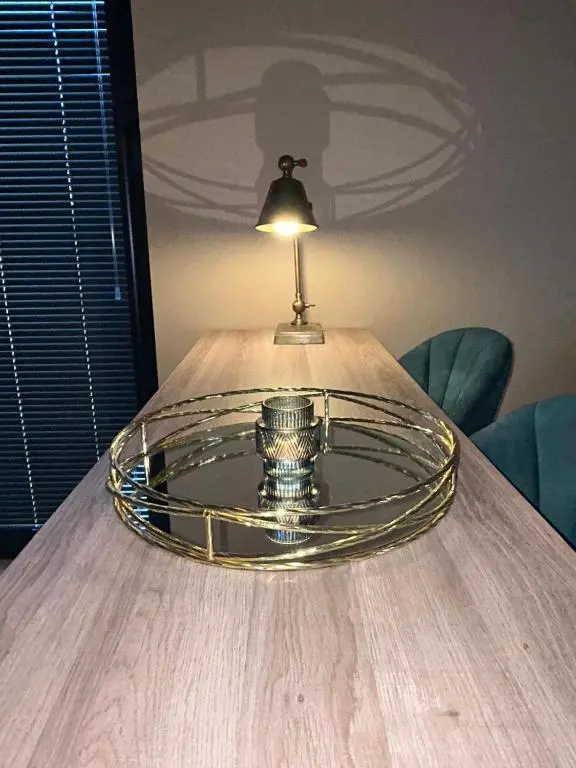 a glass plate on a table with a lamp on it at Luxury Lodge by Findhorn Sands No 18 in Findhorn