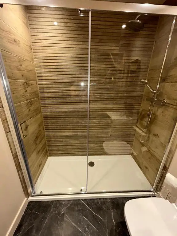 a shower with a glass door in a bathroom at Luxury Lodge by Findhorn Sands No 18 in Findhorn