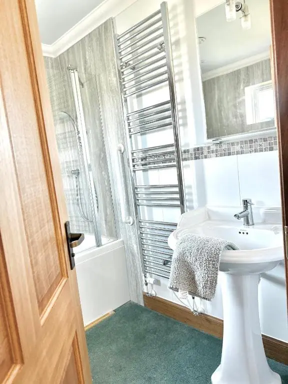 a bathroom with a white sink and a mirror at Golf View Spacious Bungalow 2 Bathrooms, Free Parking WiFi in Elgin