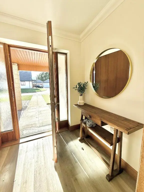 a room with a mirror and a wooden table at Golf View Spacious Bungalow 2 Bathrooms, Free Parking WiFi in Elgin