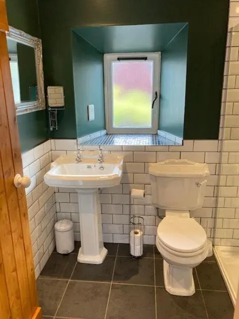 a bathroom with a toilet and a sink at Culrain Cottage in Fort Augustus