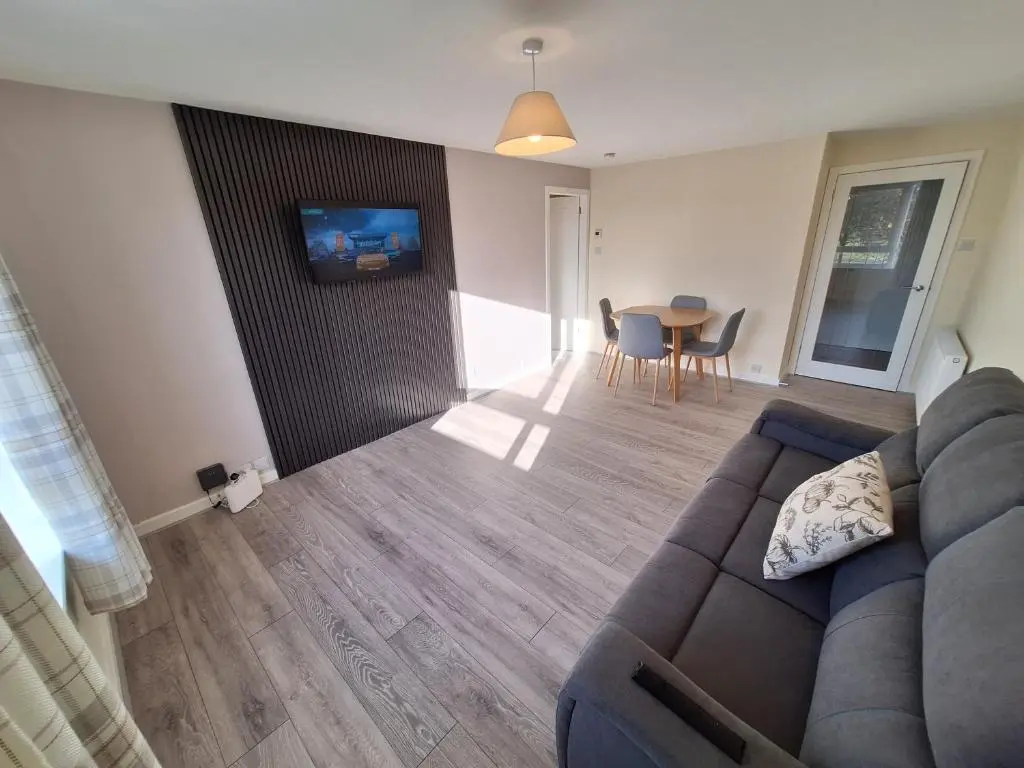 a living room with a couch and a table at Spacious Two Bed Close To City Centre!! in Dalneigh