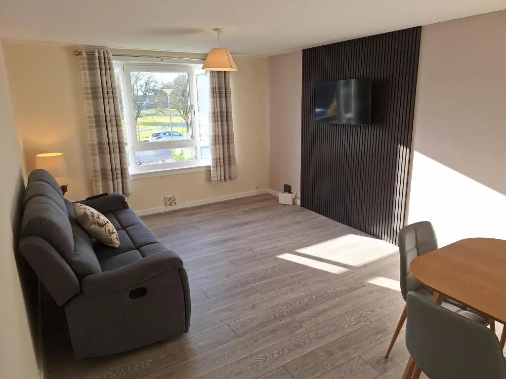 a living room with a couch and a table at Spacious Two Bed Close To City Centre!! in Dalneigh