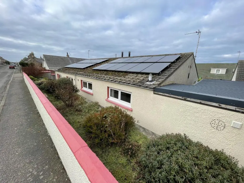 a house with solar panels on top of it at Hopeman Cottages in Hopeman