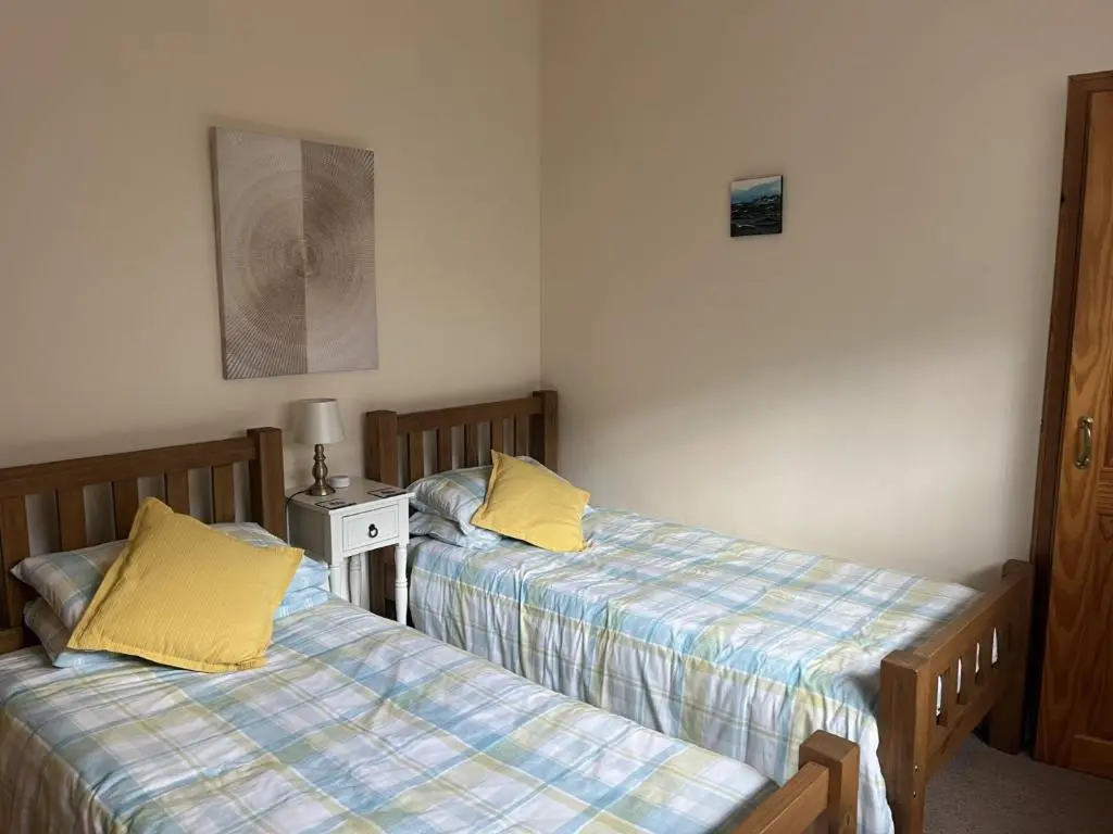 two beds sitting next to each other in a room at Hopeman Cottages in Hopeman