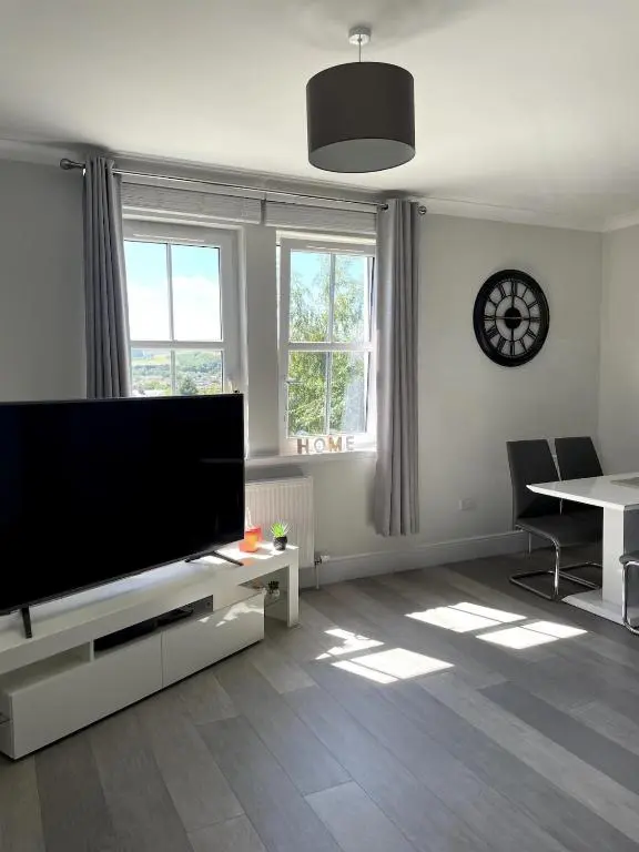 a living room with a large flat screen tv at Spacious Flat in Aberdeenshire in Insch