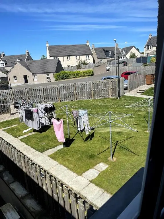 a yard with clothes drying on a clothes line at Spacious Flat in Aberdeenshire in Insch