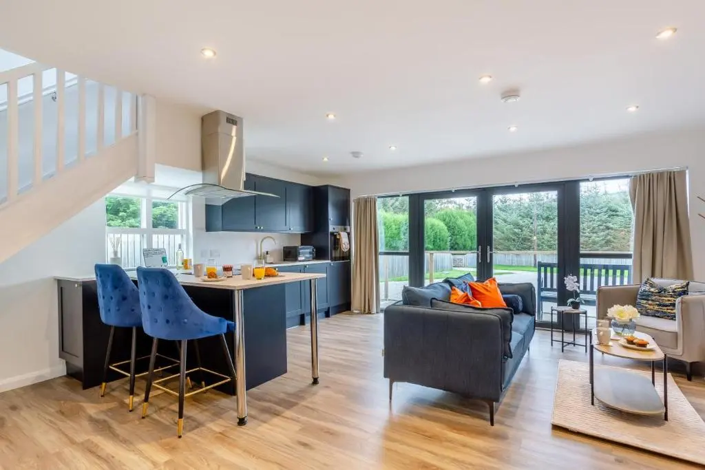 a kitchen and living room with blue cabinets at 1 Bed in Daviot oc-c33520 in Daviot