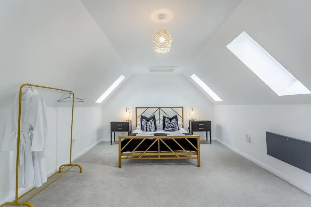 an attic room with a bed and a mirror at 1 Bed in Daviot oc-c33520 in Daviot
