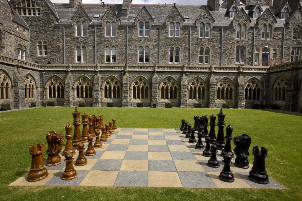 a chess board in front of a large building at Raven Wing 11 - Kintail Apartment in Fort Augustus