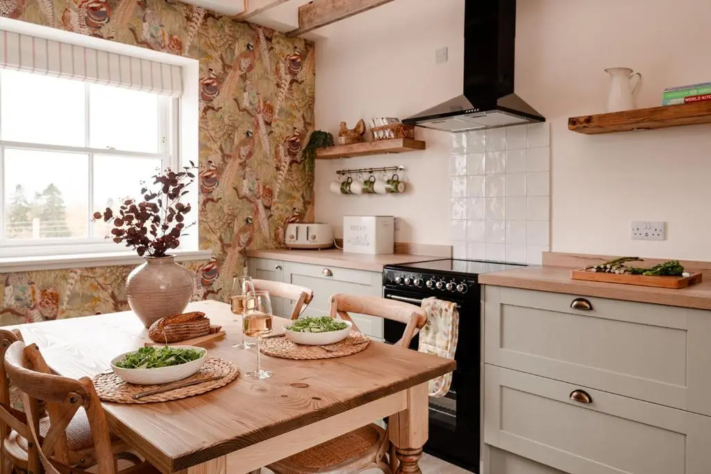 a kitchen with a wooden table with two bowls on it at Garradh Cottage - Seasgair Lodges in Kincraig